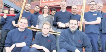  ??  ?? >
Employees at Lion Picture Framing Supplies in Bordesley