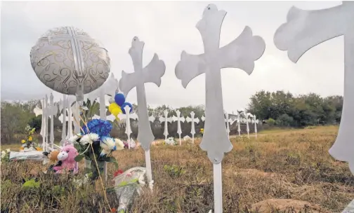  ?? COURTNEY SACCO/ USA TODAY NETWORK ?? Crosses in a field in Sutherland Springs, Texas, honor the 26 people killed at First Baptist Church. Pastor Frank Pomeroy’s 14- year- old daughter, Annabelle, was among those killed.