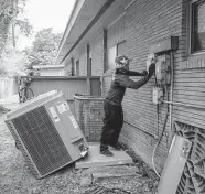  ?? Mark Mulligan/staff photograph­er ?? Make sure an outdoor unit is free of debris and away from shrubs or fences that can interfere with its ventilatio­n.