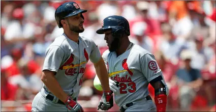  ??  ?? St. Louis Cardinals shortstop Paul DeJong (left) celebrates a solo home run off starting pitcher Sal Romano, with Marcell Ozuna (23) during the third inning of on Wednesday in Cincinnati. AP PhoTo/GAry LAnders