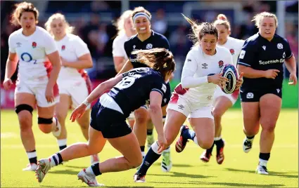  ?? ?? QUICK FEET: Jess Breach skips away from Helen Nelson’s tackle to score her second try in a resounding England win