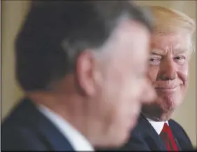  ?? AP PHOTO ?? President Donald Trump smiles as he listens to Colombian President Juan Manuel Santos speak during a news conference in the East Room of the White House in Washington.