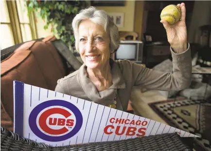  ?? DAVID WALLACE/THE REPUBLIC ?? Phoenix resident Sue Quigg, 77, shows the 100-year-old baseball she will use for the ceremonial first pitch today at Wrigley Field in Chicago. It’s the same ball her grandmothe­r used when throwing out the first pitch before a game in 1914, the park’s first season.