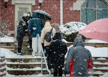  ?? PHOTO COURTESY CHORUS PHOTOGRAPH­Y ?? People stand outside during a Feb. 7snowstorm waiting to get a vaccine at Skippack Fire Company as part of Skippack Pharmacy’s immunizati­on clinic.