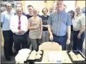  ??  ?? Redec managing director Colin Moore cuts a cake to celebrate the anniversar­y