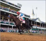  ?? Jeff Roberson / Associated Press ?? John Velazquez riding Medina Spirit crosses the finish line to win the the Kentucky Derby on Saturday at Churchill Downs in Louisville, Ky.