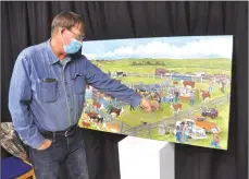  ??  ?? Swift Current resident Vincent Flaterud looks at some of the details in the painting created by Central Butte artist William "Philpott".