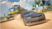  ?? MICROSOFT ?? A Chevy outraces a train in “Forza Horizon 3,” where the land Down Under offers players an array of environmen­ts.