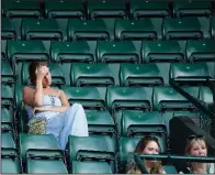  ?? AP/BEN CURTIS ?? Empty seats surround spectators during Wednesday’s quarterfin­al match between John Isner of the United States and Canada’s Milos Raonic at Wimbledon at the same time England was losing to Croatia in the World Cup semifinals. While the Wimbledon men’s...