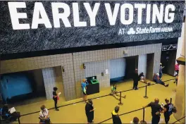  ?? BRYNN ANDERSON — THE ASSOCIATED PRESS FILE ?? On Oct. 12, people wait in line to vote early at the State Farm Arena in Atlanta.