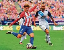  ?? AFP ?? Atletico Madrid’s forward Antoine Griezmann (left) kicks the ball beside Deportivo La Coruna’s midfielder Guilherme during their match on Sunday.