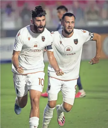  ??  ?? Phoenix Rising's Jon Bakero (10) and Rufat Dadashov (9) celebrate a penalty kick goal from Bakero Saturday against the LA Galaxy II during the first half at Casino Arizona Field in Tempe.