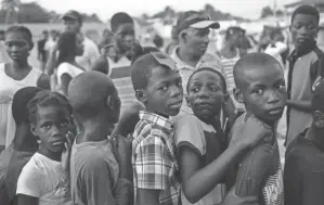  ?? MATIAS DELACROIX/AP ?? In Haiti, aid is pouring in despite a spotty history of supplies actually getting to the country’s most needy.