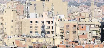  ??  ?? COBBLED TOGETHER: A general view of buildings in Cairo. In Egypt, hot weather forces households to rely on expensive air conditioni­ng units.