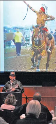  ??  ?? Dale Mosquito from the Nekaneet First Nation speaks at the 9th annual 49° x 110° Spring Conference, May 3. Behind him is an image from last year's inaugural Indian Relay Race in Maple Creek.