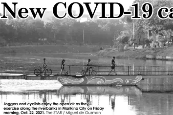  ?? The STAR / Miguel de Guzman ?? Joggers and cyclists enjoy the open air as they exercise along the riverbanks in Marikina City on Friday morning, Oct. 22, 2021.