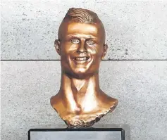  ??  ?? A bust of Cristiano Ronaldo is seen before the ceremony. — Reuters photo