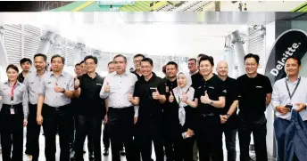  ?? ?? Loke (front, fourth from left) with management and representa­tives of Deloitte at the unveiling of the TTDI Deloitte MRT station.