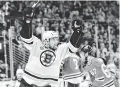  ?? ROB GRABOWSKI, USA TODAY SPORTS ?? Daniel Paille celebrates Saturday after scoring in overtime to give the Bruins a 2- 1 win vs. the Blackhawks and a 1- 1 tie in the series.