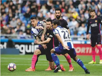  ??  ?? Stopped...Deportivo La Coruna get to grips with Sergio Busquets of Barcelona