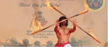  ?? Associated Press ?? ↑
An artist performs during a car rally of National Security Guard Black Cats in Hyderabad, Telangana, on Sunday.