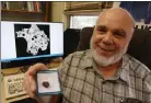  ?? JULIa MaLakIe / LoweLL sUN ?? UMass Lowell geology professor Nelson eby in his office, with a sample of red trinitite formed from sand and other materials melted in the first atomic bomb test in New Mexico. The red trinitite contains melted copper from wiring that was on the nuclear test site.