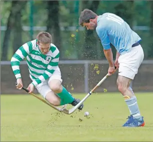  ?? Photograph: Stephen Lawson. ?? Oban Celtic’s Daniel Madej takes evasive action as Caberfeidh’s Blair Morrison clears his lines at Mossfield last Saturday in a National Division game which the visitors won 6-1.