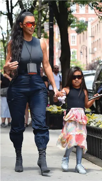  ?? Picture: JOSIAH KAMAU/BUZZFOTO VIA GETTY IMAGES ?? GETTING RIGHT IN STEP: Kim Kardashian and North West seen on the streets of Manhattan in New York.