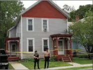  ??  ?? Glens Falls police and Warren County Sheriff’s officers are stationed outside a South Street home in Glens Falls where a woman and her daughter were found dead Friday morning.