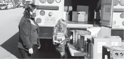  ?? COURTESY OF HAMPTON CITY SCHOOLS ?? A student chooses a book from one of Hampton’s book buses on Nov. 20.