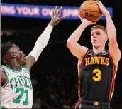  ?? Kevin C. Cox / Getty Images ?? Kevin Huerter (3) of the Atlanta Hawks went 5 of 6 from 3-point range to score 19 points against the Boston Celtics Wednesday.