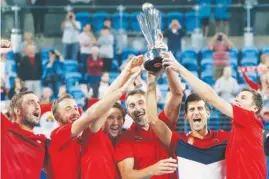  ?? (AP) ?? LED by Novak Djokovic, Serbian squad celebrates after winning the ATP Cup.