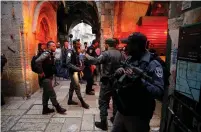  ?? (Ammar Awad/Reuters) ?? SECURITY FORCES stand near the site where a man was stabbed and critically wounded in the Old City of Jerusalem yesterday.