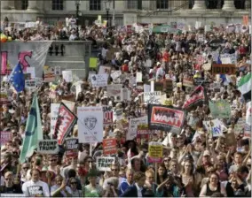  ?? TIM IRELAND — THE ASSOCIATED PRESS ?? Protestors holding banners gather after a march opposed to the visit of U.S. President Donald Trump in Trafalgar Square in London, Friday.