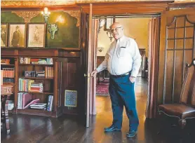  ??  ?? Owner Steve Carver walks through the doorway into the library of the recently restored Redstone Castle in Redstone.