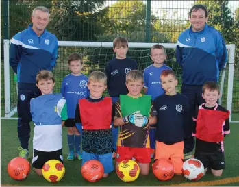  ??  ?? A young group at Sunday’s squad training session in the Shamrock Rovers grounds in Enniscorth­y with coaches Jimmy O’Neill and ‘Tucker’ O’Brien.