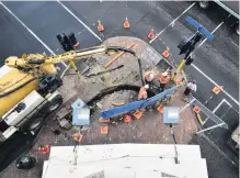  ?? PHOTOS: GREGOR RICHARDSON ?? View from above . . . Downer’s contract staff undertake work at the corner of Cumberland and Lower Stuart Sts, Dunedin, this week.