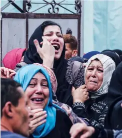  ?? Agence France-presse ?? Relatives of Palestinia­n Naji Al Za’aneen mourn during his funeral in the northern Gaza Strip on Wednesday.