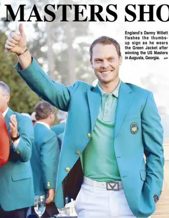  ?? AFP ?? England’s Danny Willett flashes the thumbsup sign as he wears the Green Jacket after winning the US Masters in Augusta, Georgia.