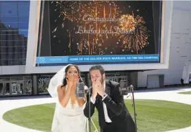  ?? Yalonda M. James / The Chronicle ?? Lindsay and Dustin Schneider celebrate after their wedding at Chase Center. Warriors rookie Jordan Poole was their witness and Rebeca Delgadillo the officiant for a ceremony meant to be held at Disney World.