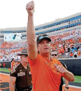  ?? [PHOTO BY SARAH PHIPPS, THE OKLAHOMAN] ?? Coach Mike Gundy’s Oklahoma State Cowboys moved up to No. 15 in The Associated Press and coaches’ polls on Sunday.