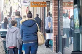  ?? Don Leach
Coastline Pilot ?? PEDESTRIAN­S browse along Forest Avenue. Merchants said they saw fewer shoppers strolling city streets in December compared with previous years.