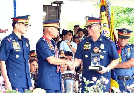  ??  ?? Outstandin­g cops National Capital Region Police Director Guillermo Eleazar (left) assists PNP Chief Oscar Albayalde in handing out awards during the 118th Police Service Anniversar­y of the NCRPO at Camp Bagong Diwa in Taguig City.