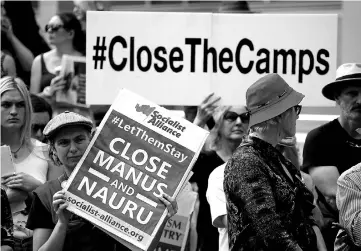  ??  ?? File photo of protesters from the Refugee Action Coalition hold placards during a demonstrat­ion outside the offices of the Australian Government Department of Immigratio­n and Border Protection in Sydney. — Reuters photo