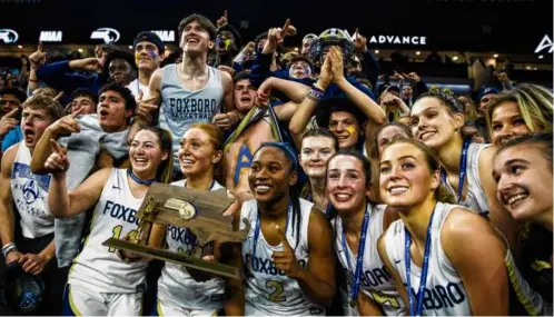  ?? ERIN CLARK/GLOBE STAFF ?? Competing in their first state title game, the Foxborough girls weren’t fazed, beating Dracut to claim the trophy.