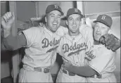  ?? THE ASSOCIATED PRESS ?? Brooklyn Dodgers pitcher Carl Erskine, center, celebrates with teammate Duke Snider, left, and manager Charley Dressen after beating the Yankees 6-5in Game 5of the World Series at Yankee Stadium in New York, Oct. 5, 1952.