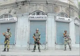  ?? PTI ?? BSF jawans stand guard during a curfew in Srinagar on Monday.