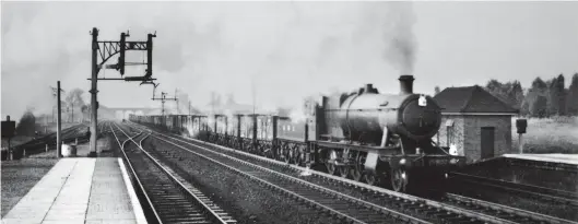  ?? P J Lynch/Kiddermins­ter Railway Museum ?? On Wednesday, 18 August 1948 class ‘2884’ 2-8-0 No 3803 heads north through Welwyn Garden City with the second of its two down preliminar­y runs to New England yard, a lengthy load of empty coal wagons and a brake van. Although the ‘2800’ design dates back to the first decade of the 20th century the 1938-built No 3803 proved to be as good, if not better than some of its more modern competitor­s, although on its home region its coal consumptio­n was higher than when running on the other regions. When tested later on the Western Region and burning Welsh steam coal the Churchward 2-8-0s proved to be even more efficient.