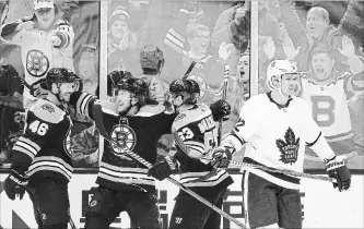  ?? MICHAEL DWYER THE ASSOCIATED PRESS ?? Boston Bruins’ David Krejci (46) celebrates his goal with teammates Brad Marchand (63) and David Pastrnak as Toronto Maple Leafs’ Nikita Zaitsev skates away during the third period Saturday. Krejci had a goal and an assist to pass Hall of Famer Cam Neely for 10th on the Bruins’ all-time scoring list.