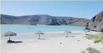  ?? DAVID DYCK ?? La Paz locals take pride in the fact that some beaches have remained developmen­t-free, preserving the pristine sand and water. At left, the CostaBaja Resort features a hotel, restaurant­s and pools.